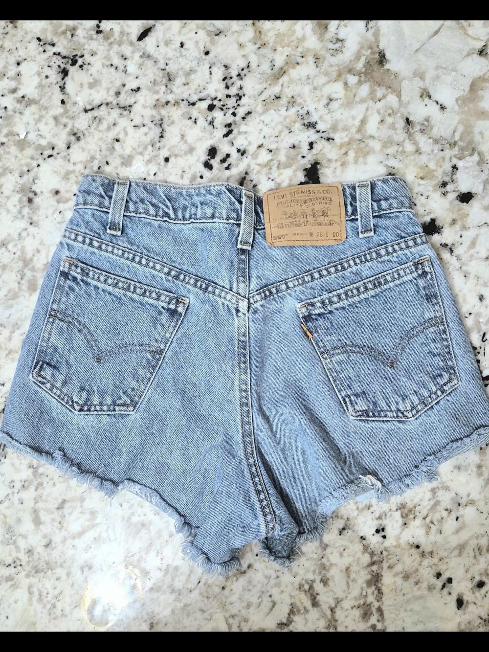 Vintage Levi's 550 Light Wash Denim Cutoff Shorts with Frayed Hem Size 28